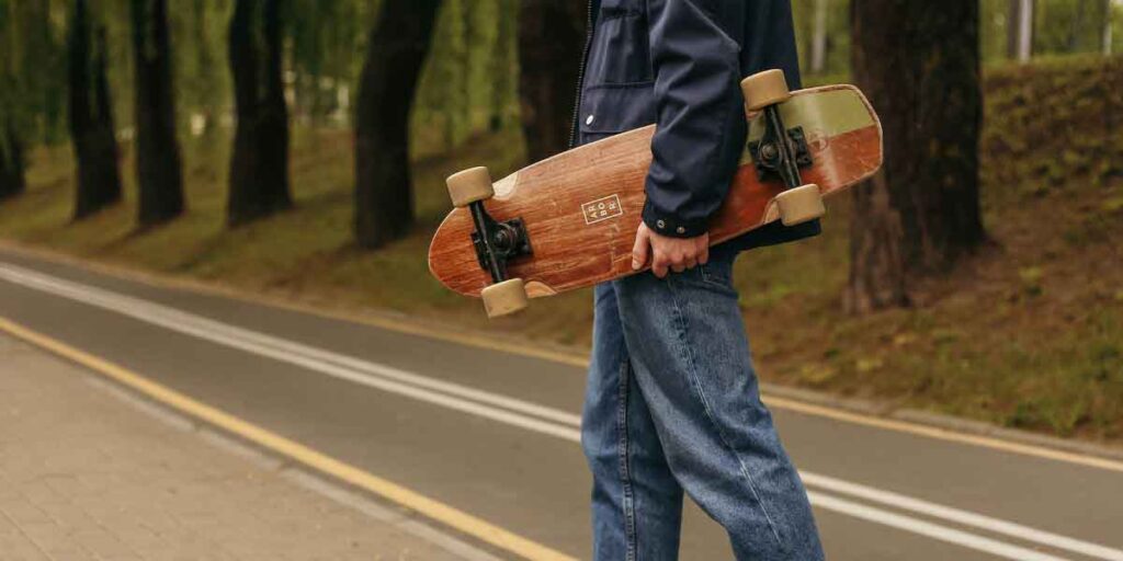 how much does a skateboard weigh?- blog post image. A person is carrying a skateboard